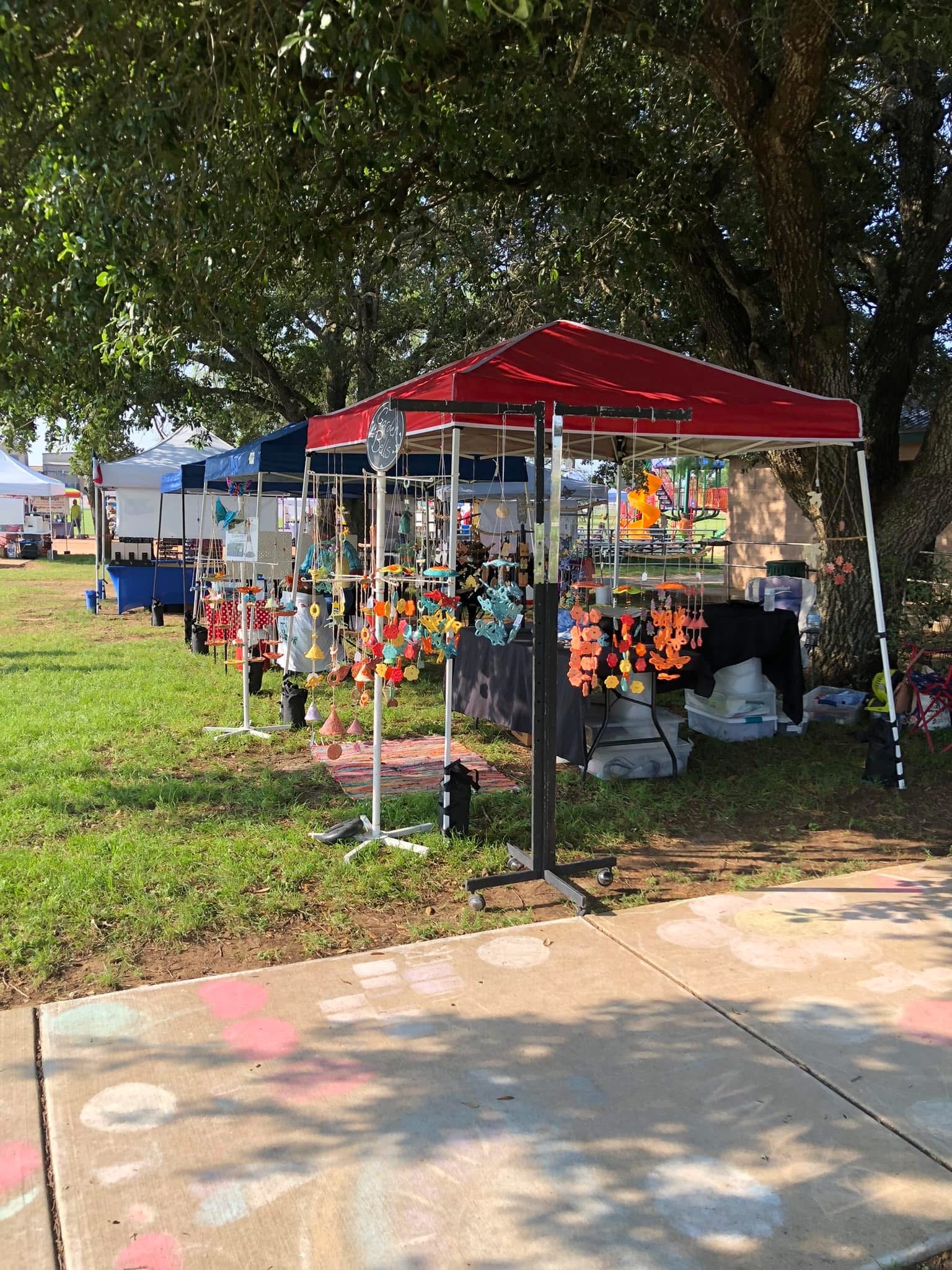 Pottery booth beneath a red canopy